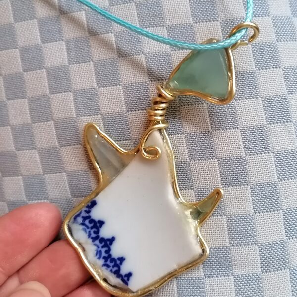 Beautifully handcrafted, framed with golden wire, with ceramic &amp; sea glass combined